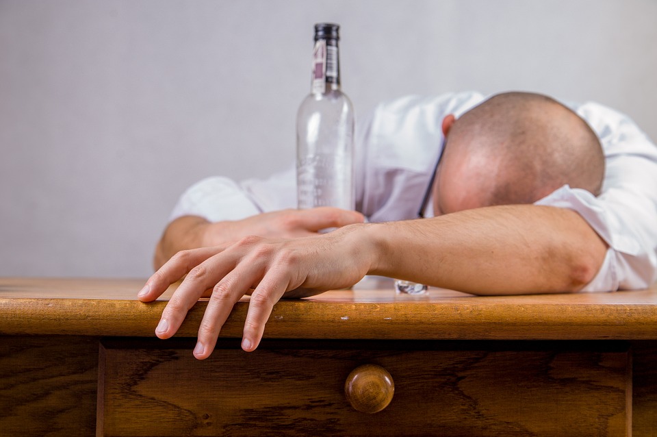 man sleeping while holding bottle